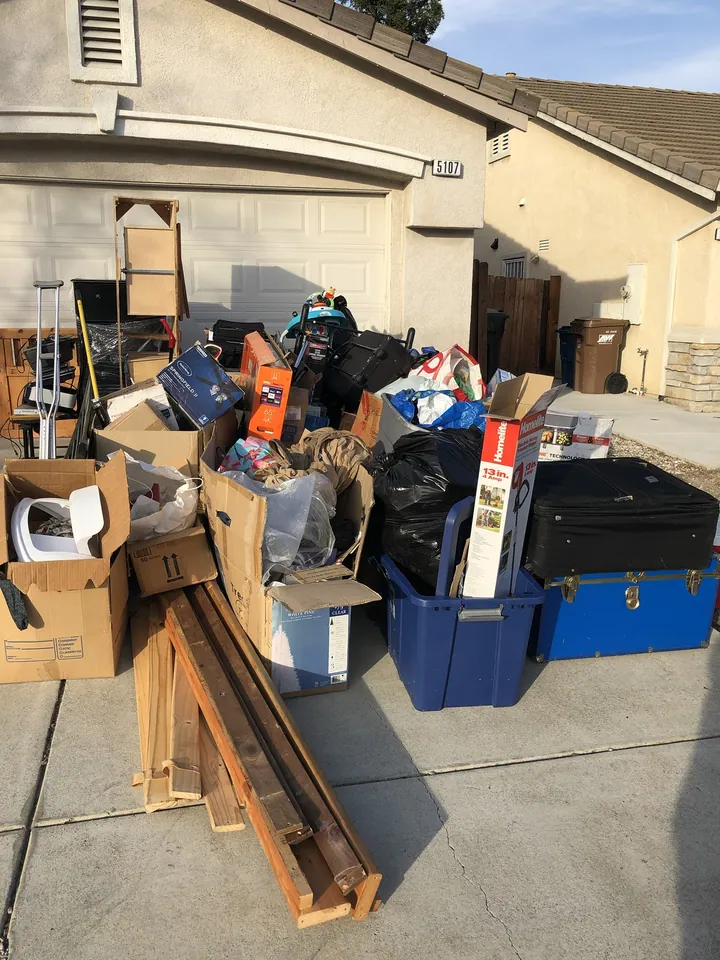 A household cleanout staged in the driveway before it goes on the truck.