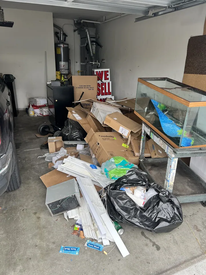 A garage that had stopped being a garage. The tank, the boxes and the blinds all went.
