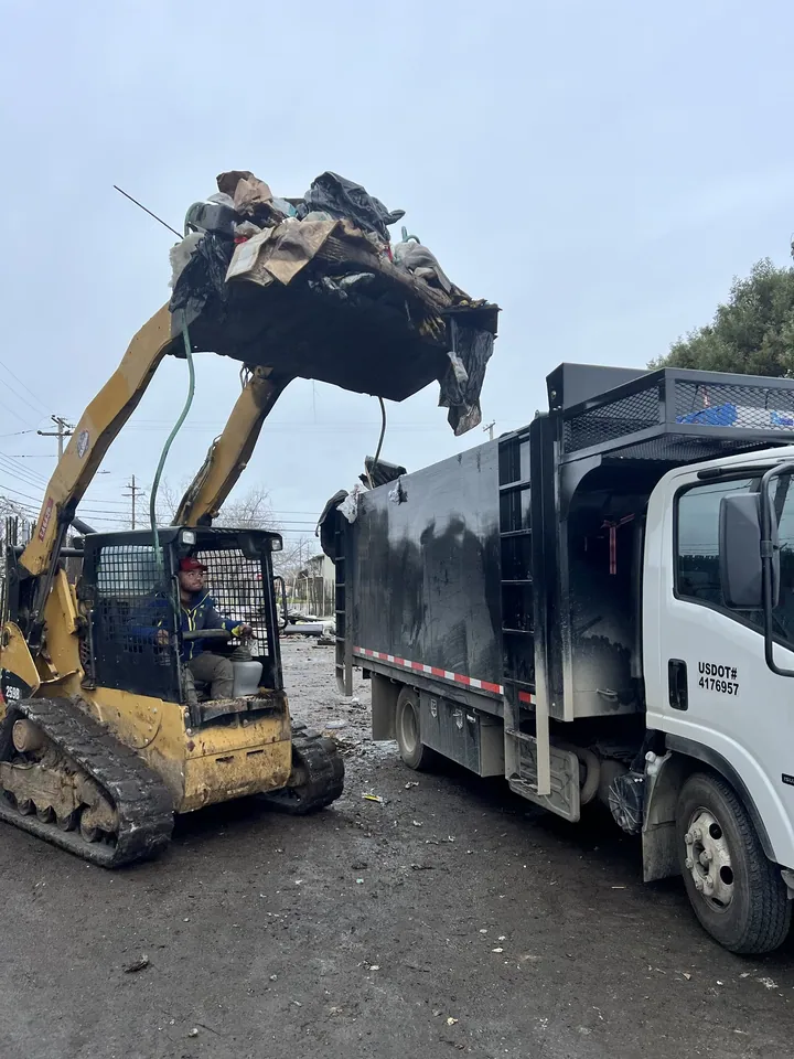 Bigger demolition loads get machine help instead of six more hours of lifting.