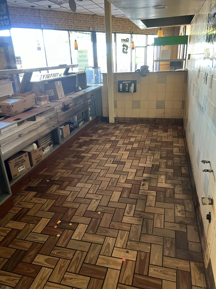 Finished. A clear floor is the actual product, not a half emptied room.