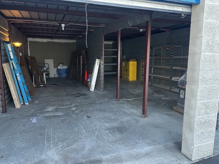 The same type of storage unit, completely empty with a swept concrete floor